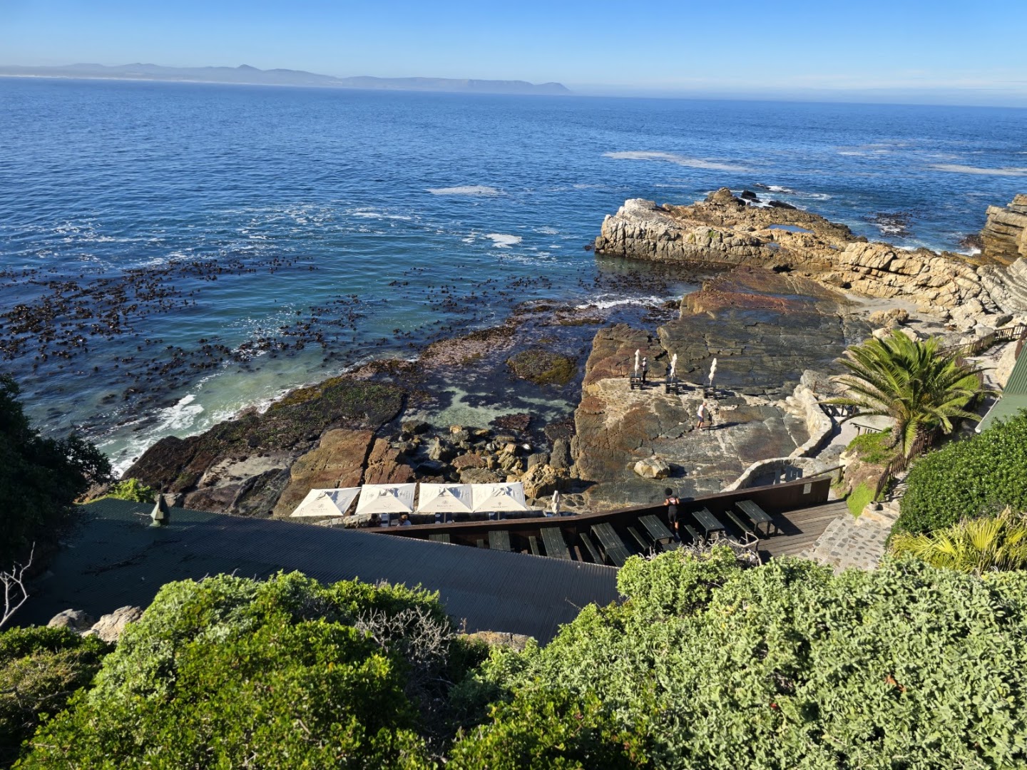 Whale watching boats moored at Hermanus New Harbour with mountain backdrop